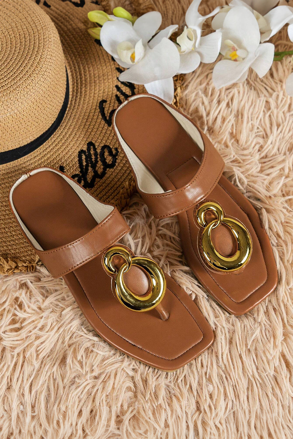 Brown flat slippers featuring decorative metal rings and a square toe design, perfect for stylish comfort.