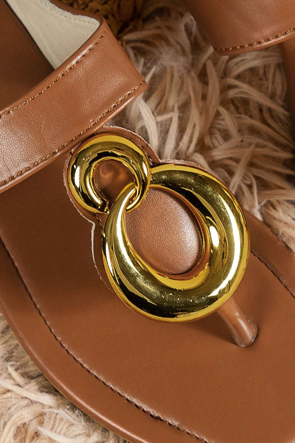 Brown flat slippers featuring decorative metal rings and a square toe design, perfect for stylish comfort.