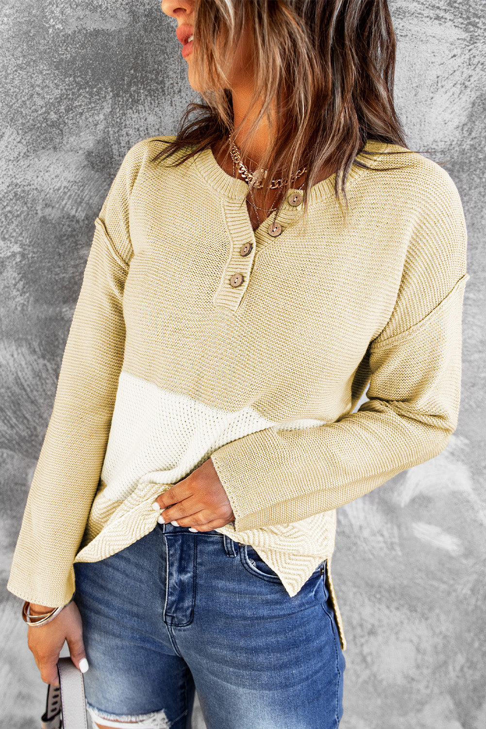 A stylish brown knitted long sleeve sweater featuring color splicing and buttoned design, perfect for casual outfits.