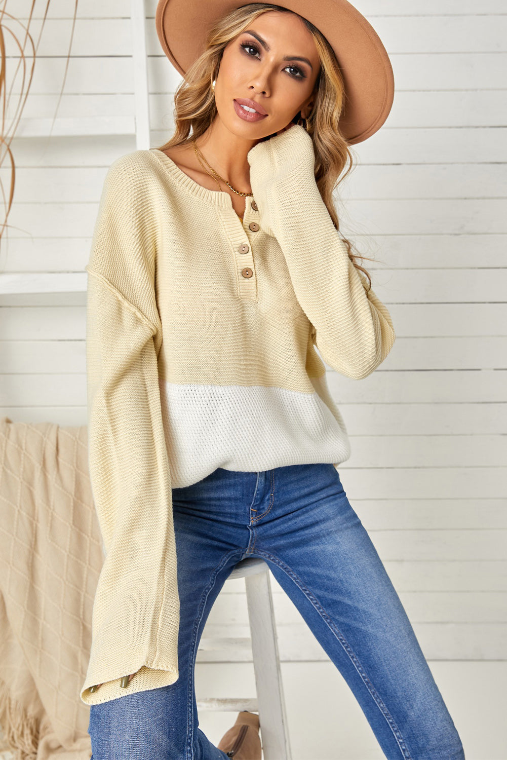 A stylish brown knitted long sleeve sweater featuring color splicing and buttoned design, perfect for casual outfits.