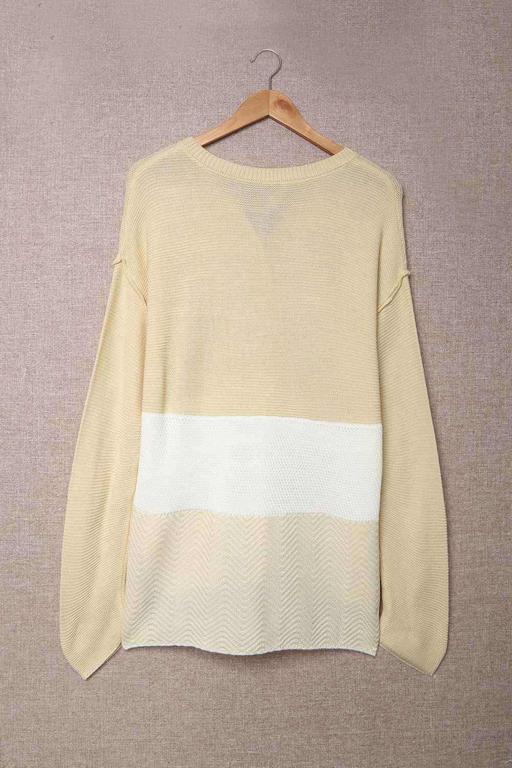 A stylish brown knitted long sleeve sweater featuring color splicing and buttoned design, perfect for casual outfits.