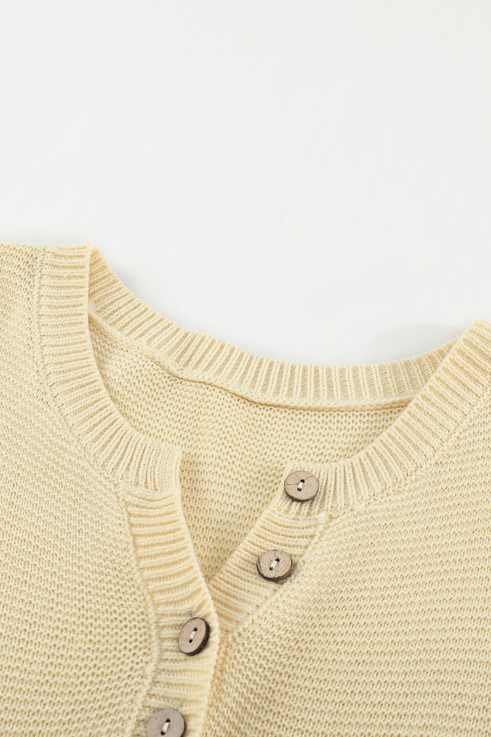 A stylish brown knitted long sleeve sweater featuring color splicing and buttoned design, perfect for casual outfits.