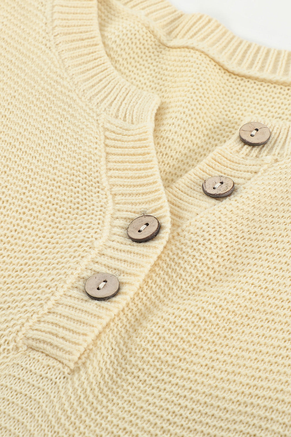 A stylish brown knitted long sleeve sweater featuring color splicing and buttoned design, perfect for casual outfits.