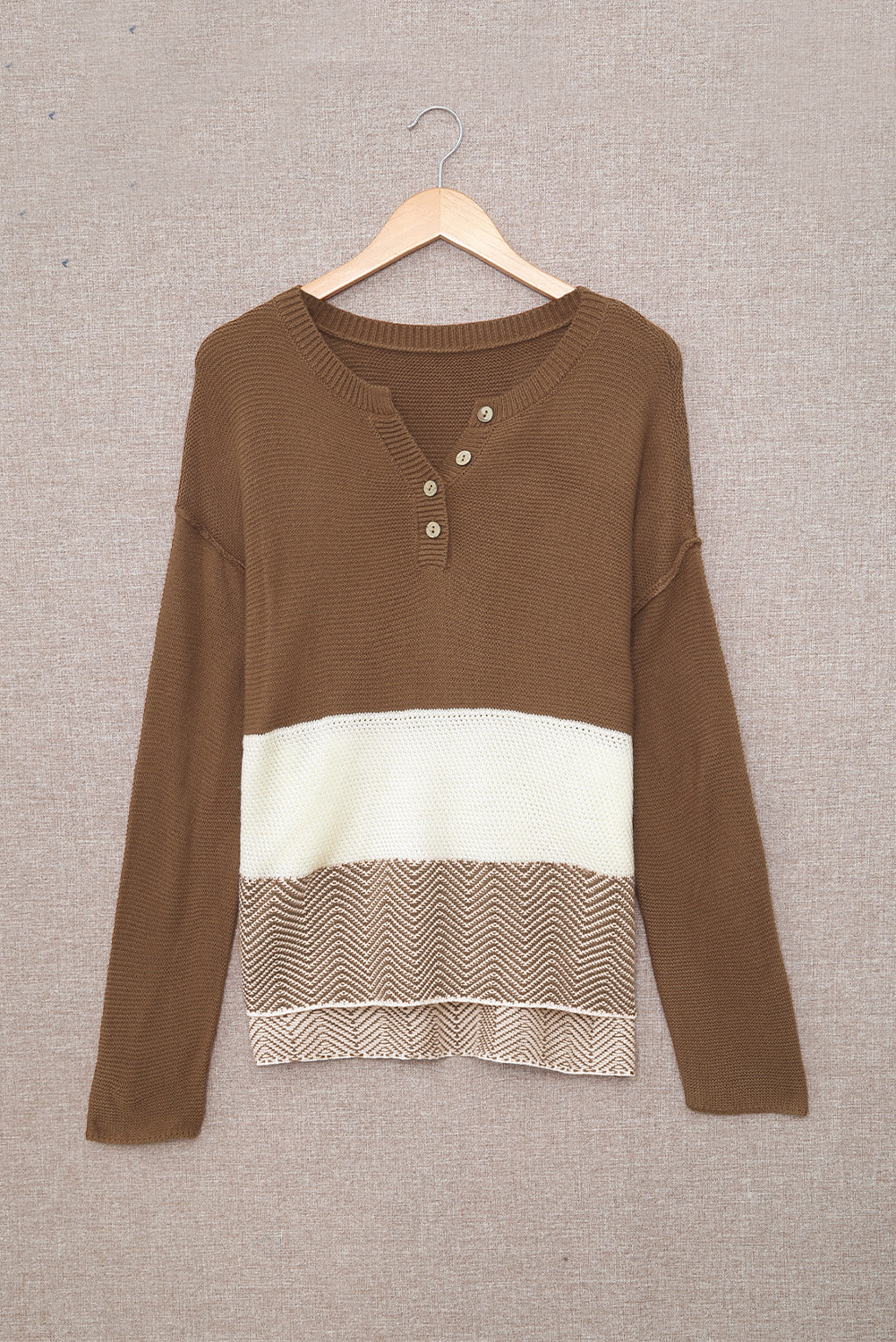 A stylish brown knitted long sleeve sweater featuring color splicing and buttoned design, perfect for casual outfits.