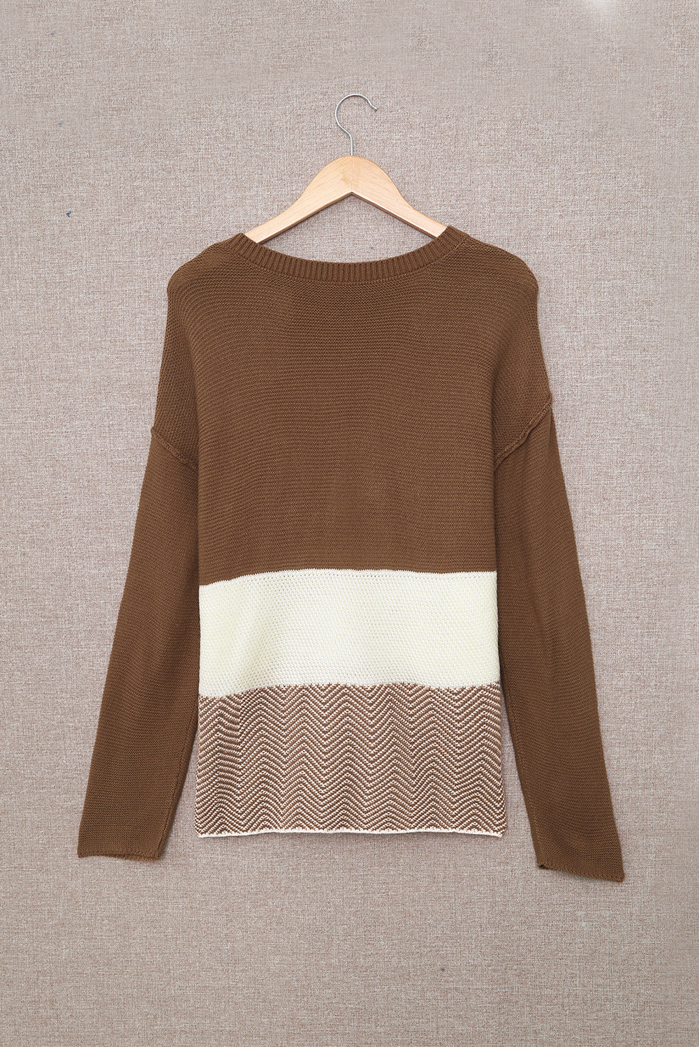 A stylish brown knitted long sleeve sweater featuring color splicing and buttoned design, perfect for casual outfits.