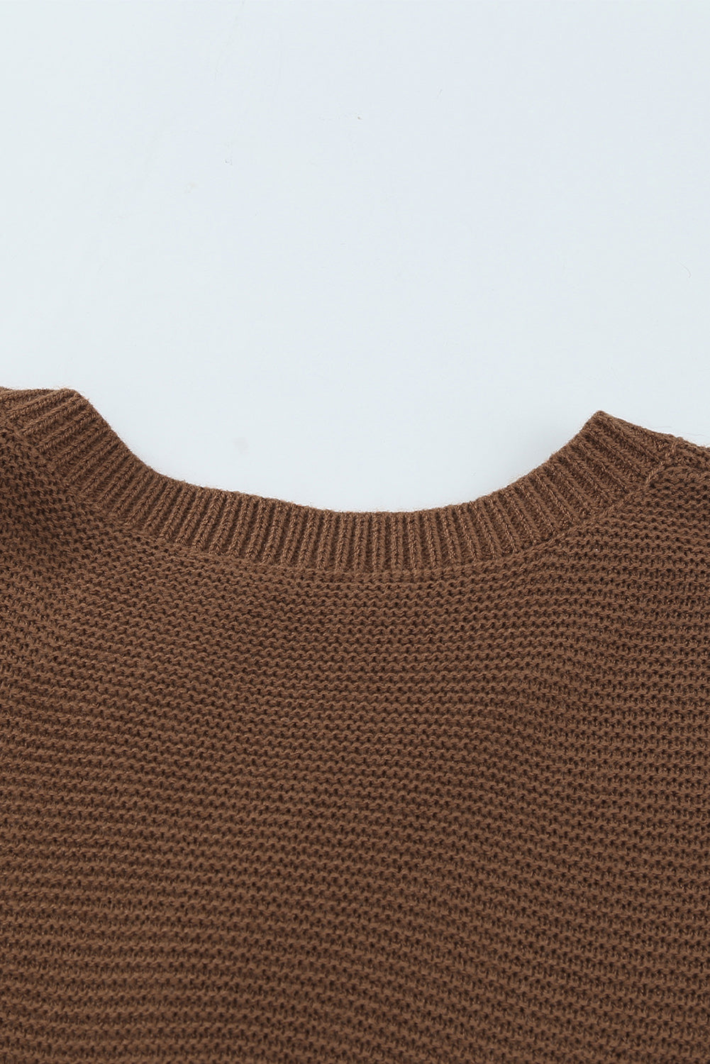 A stylish brown knitted long sleeve sweater featuring color splicing and buttoned design, perfect for casual outfits.