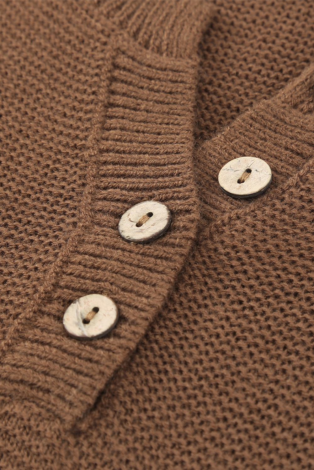 A stylish brown knitted long sleeve sweater featuring color splicing and buttoned design, perfect for casual outfits.