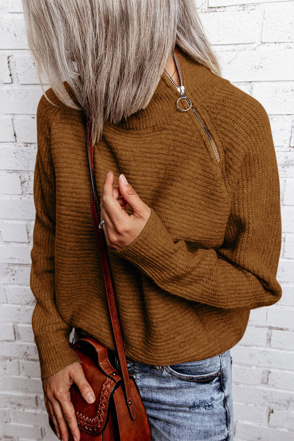 A stylish brown zip knitted high neck sweater displayed on a mannequin, showcasing its soft texture and modern design.