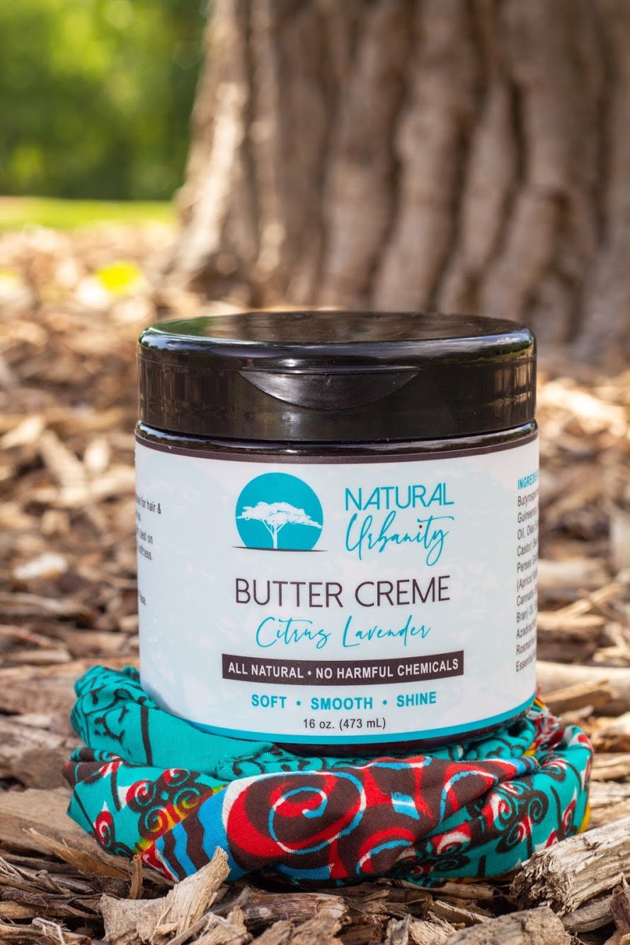 A jar of Butter Creme showcasing its creamy texture, perfect for moisturizing hair and skin.