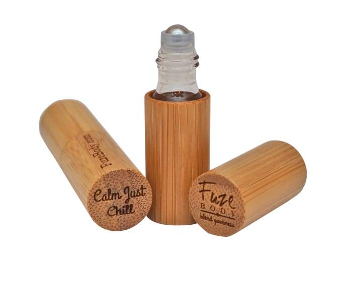 Calm - Just Chill Wood Roll-On Pure Essential Oils in a wooden container, showcasing its soothing blend of essential oils.