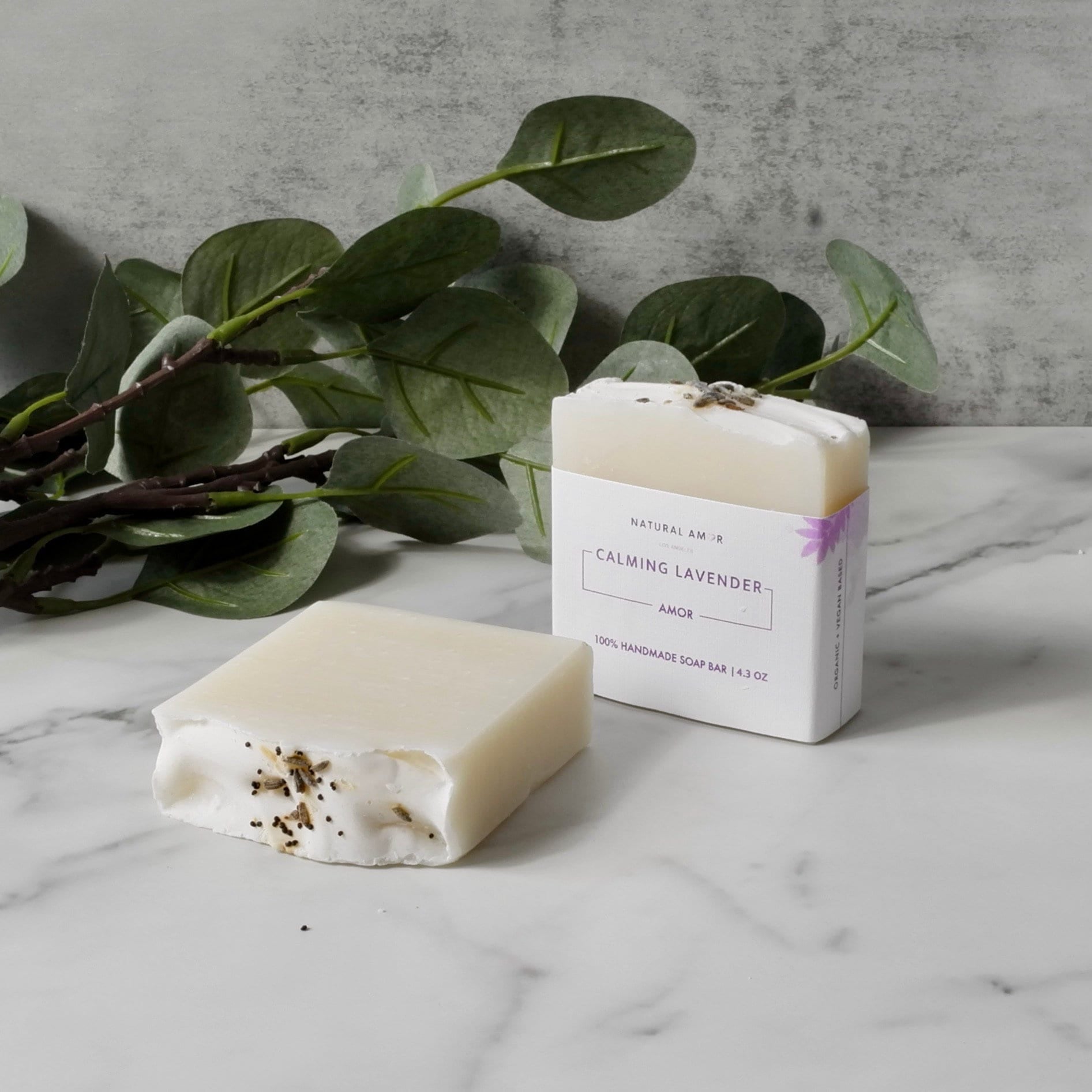 Calming Lavender Soap Bar with natural ingredients, featuring a soothing lavender color and dried lavender pieces.