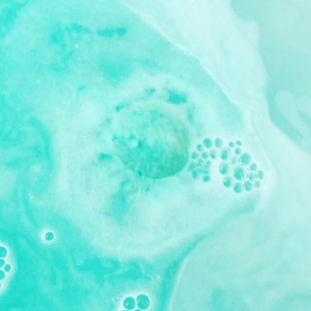 Calypso Bath Bomb in vibrant colors with aloe and cucumber scent, showcasing its handmade quality.