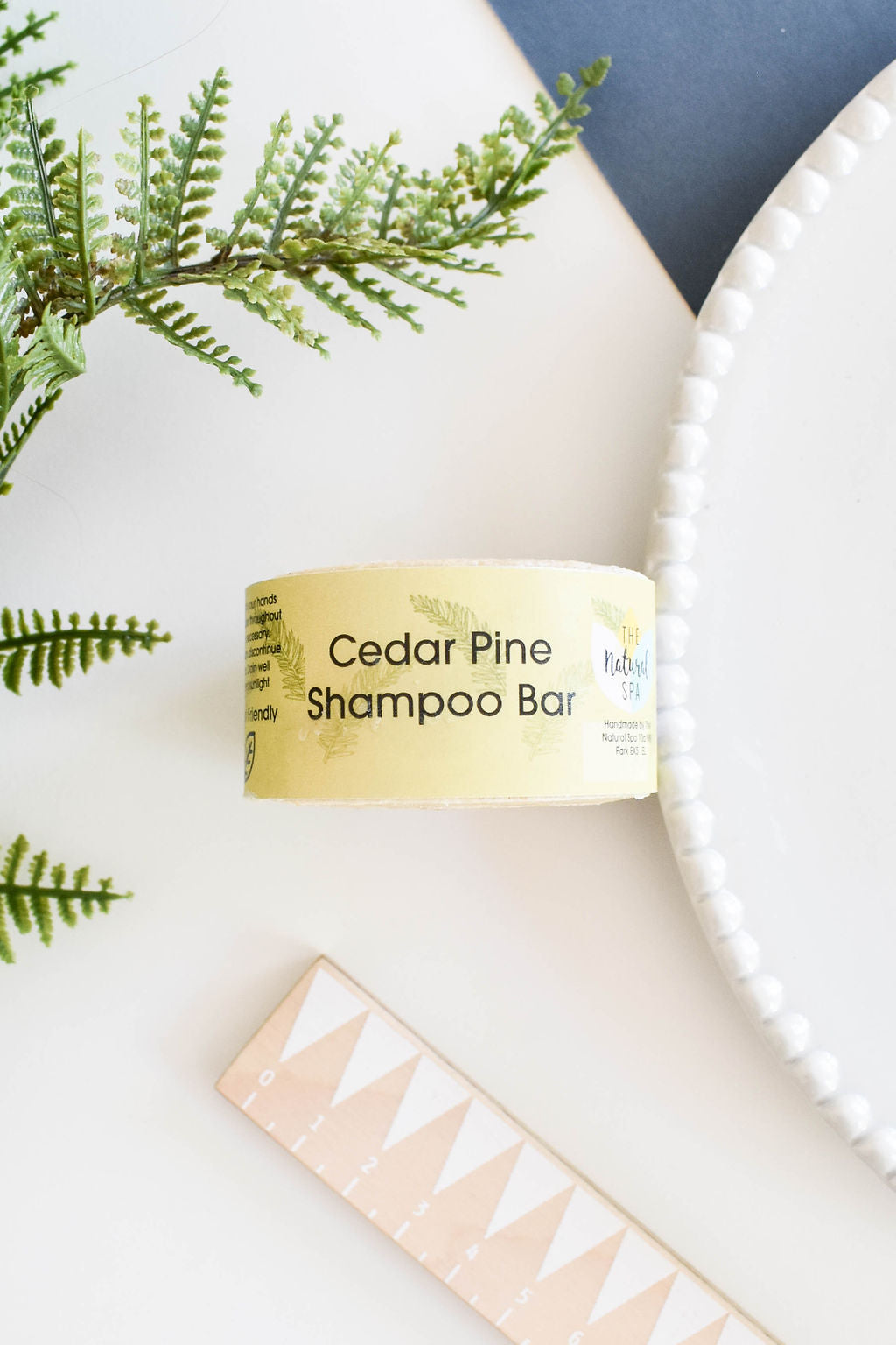 Cedarwood and Pine Shampoo Bar, a plastic-free solid shampoo with natural ingredients, displayed on a wooden surface.