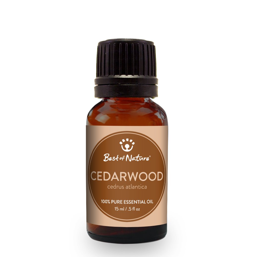 A bottle of 100% pure Cedarwood Atlas Essential Oil with a wooden background, showcasing its natural essence.