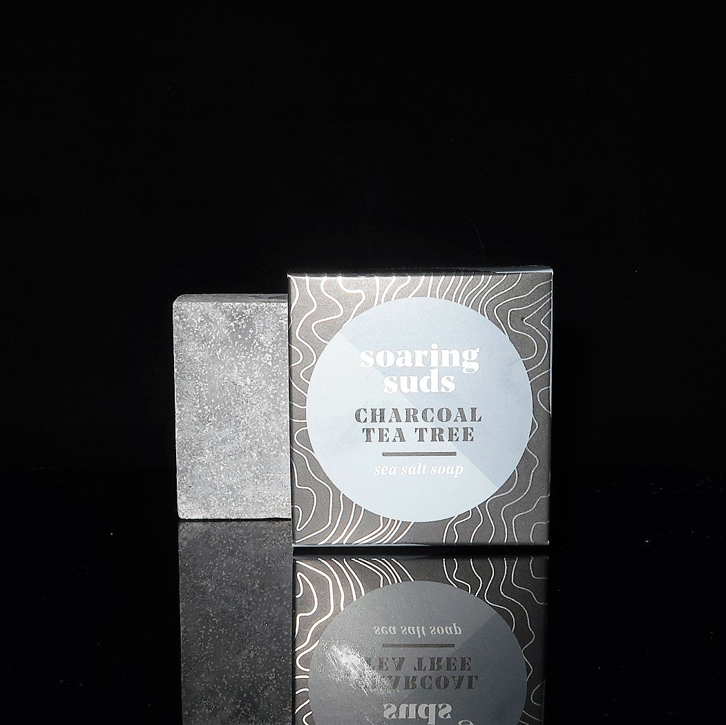 Charcoal Tea Tree Sea Salt Spa Bar with natural ingredients, showcasing its unique texture and color.