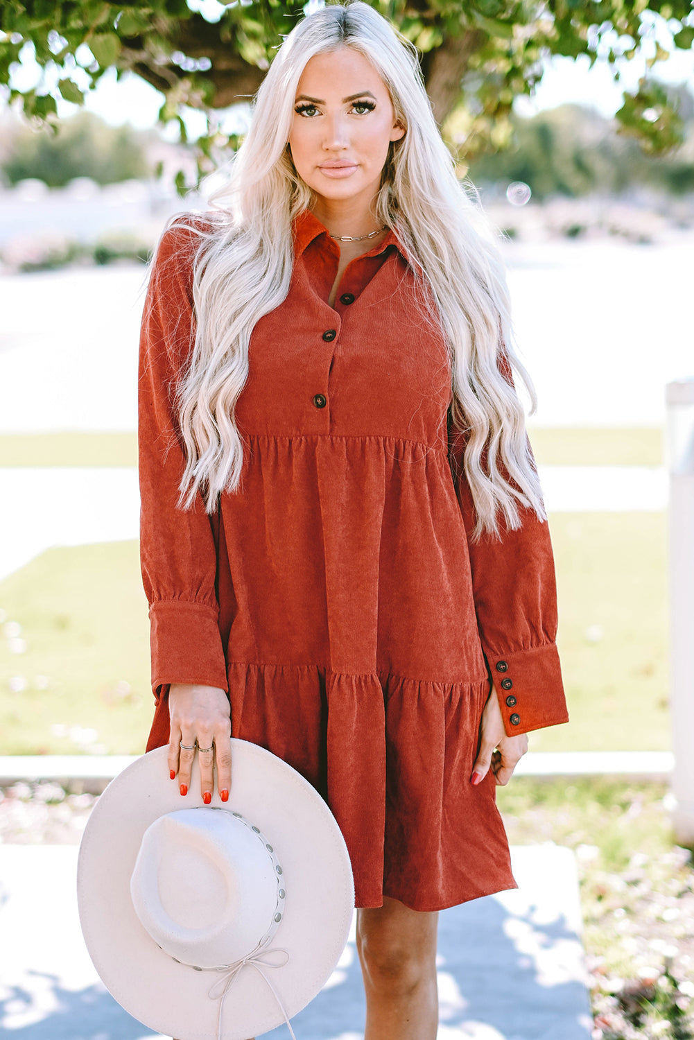 Chestnut corduroy mini dress with tiered frills, button front, and pockets, perfect for stylish autumn wear.