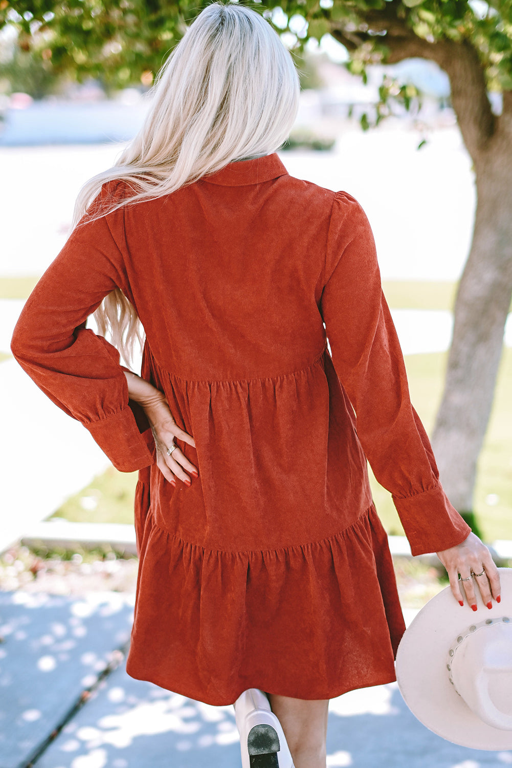 Chestnut corduroy mini dress with tiered frills, button front, and pockets, perfect for stylish autumn wear.