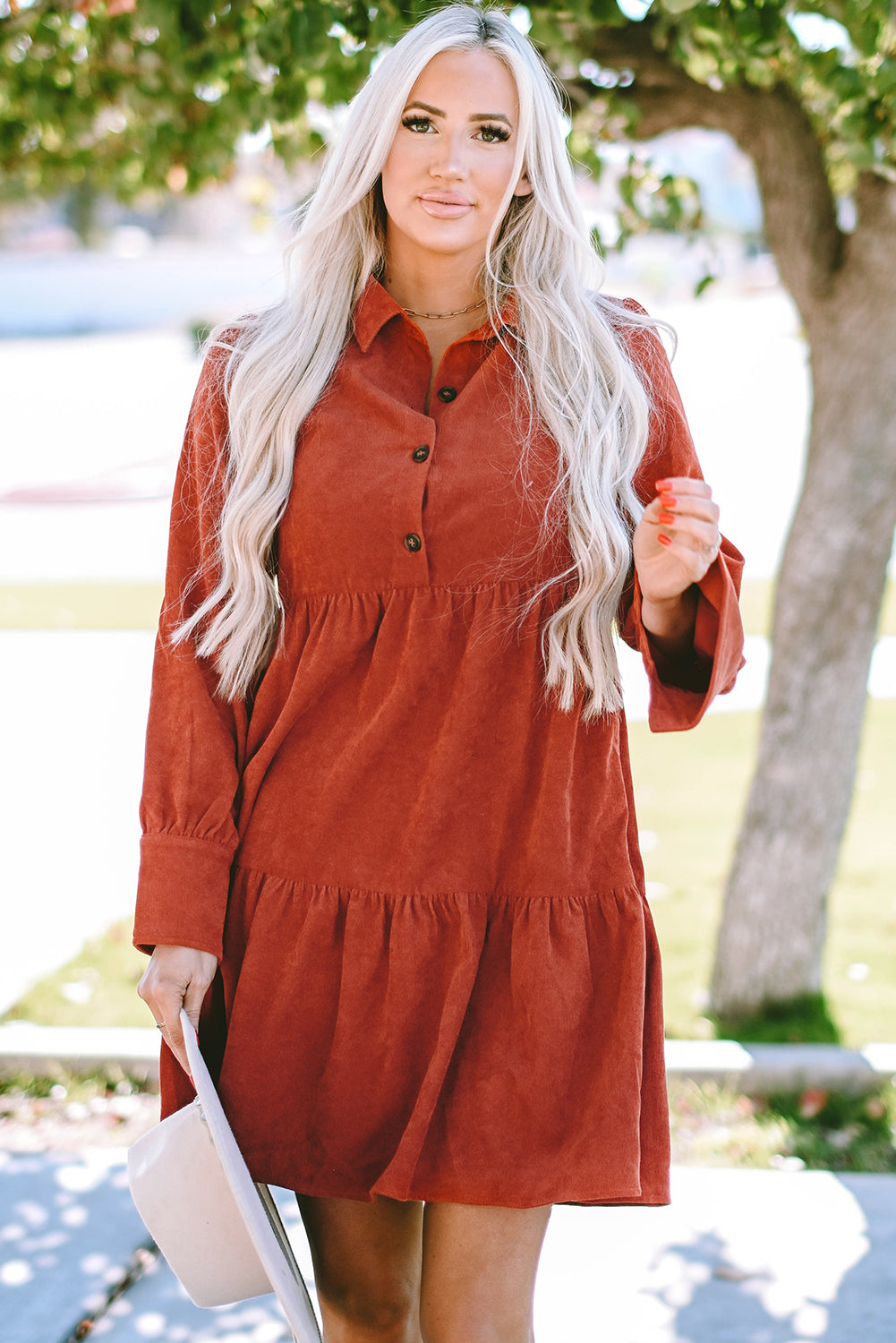 Chestnut corduroy mini dress with tiered frills, button front, and pockets, perfect for stylish autumn wear.