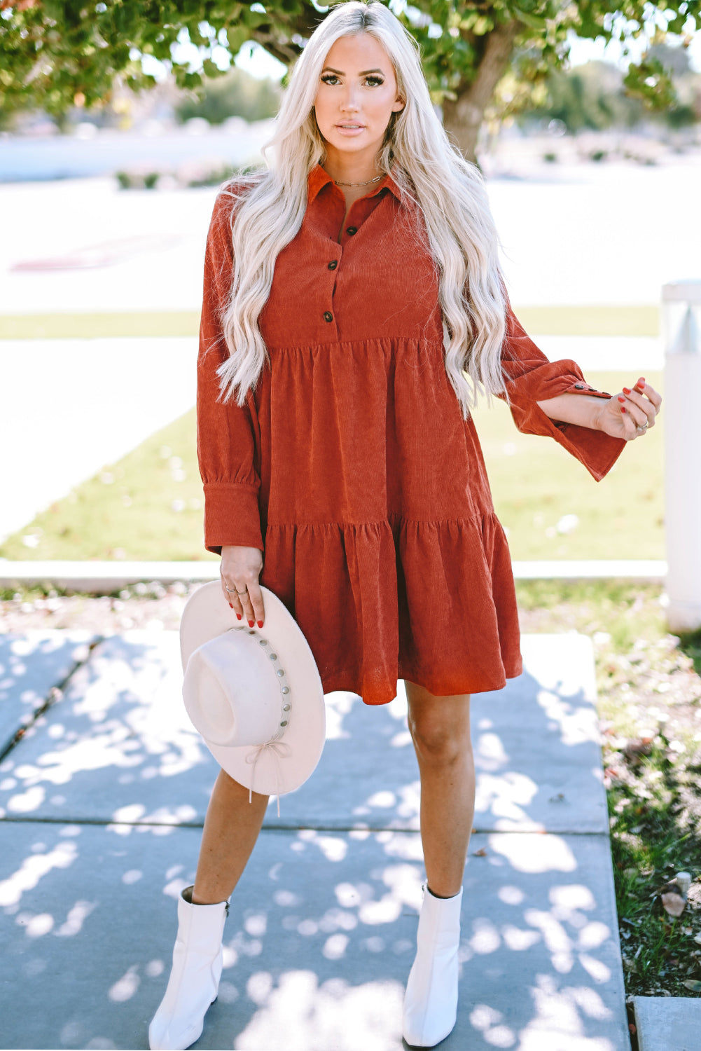 Chestnut corduroy mini dress with tiered frills, button front, and pockets, perfect for stylish autumn wear.