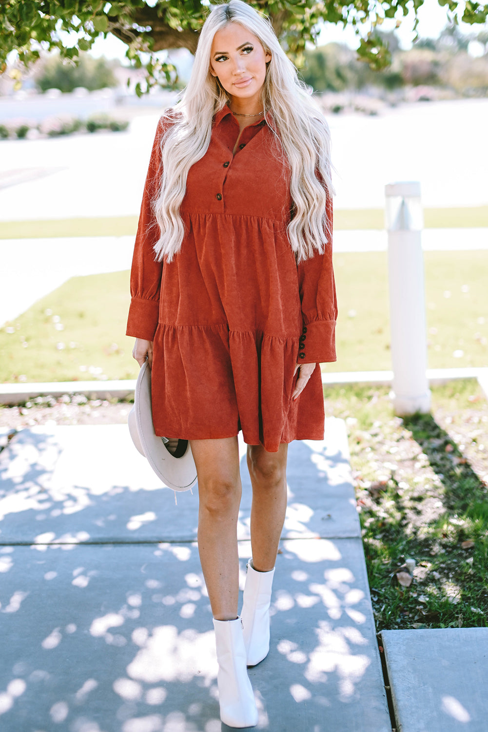 Chestnut corduroy mini dress with tiered frills, button front, and pockets, perfect for stylish autumn wear.