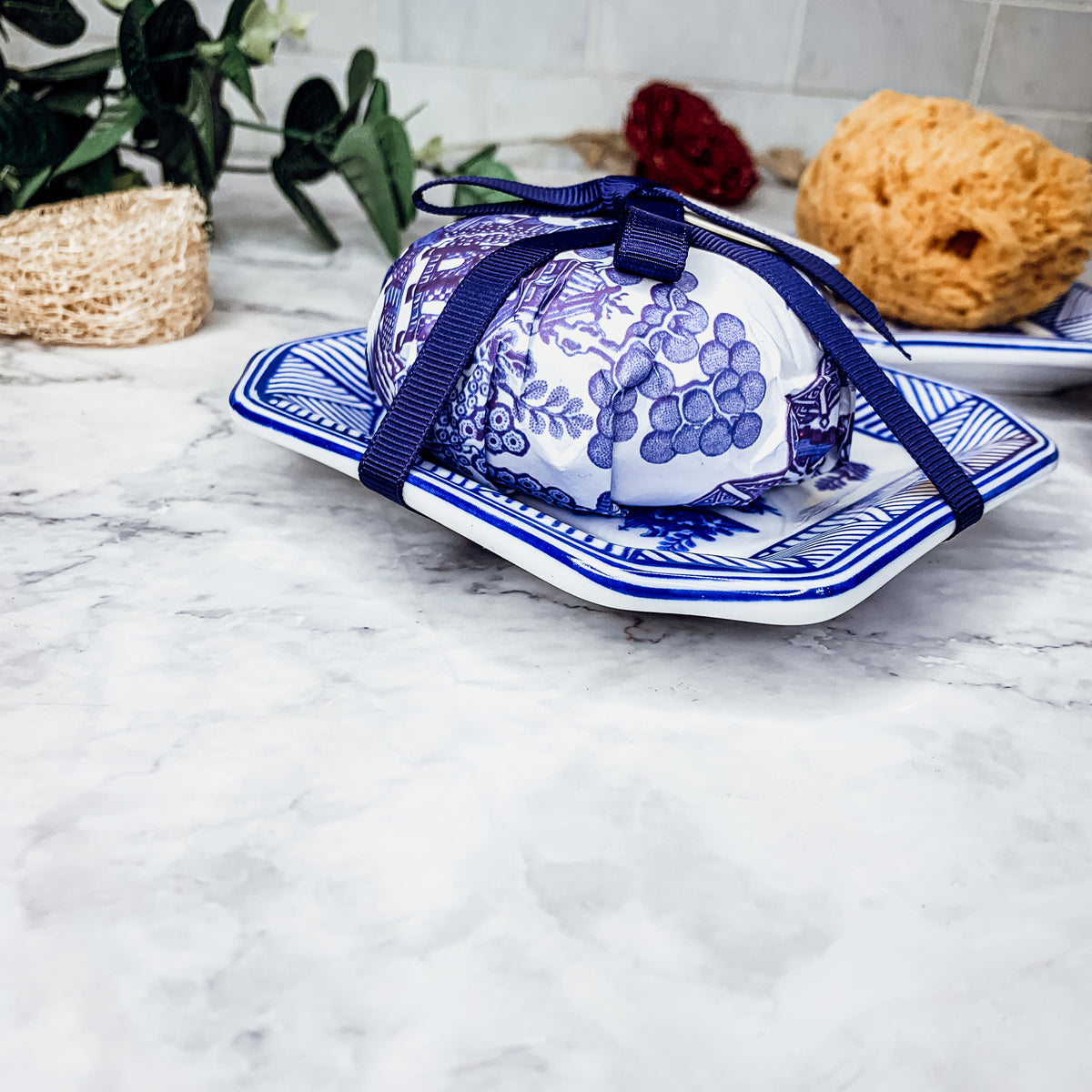 Chinoiserie Soap & Dish Set featuring a sandalwood scented soap on a blue and white porcelain tray, elegantly embossed design.