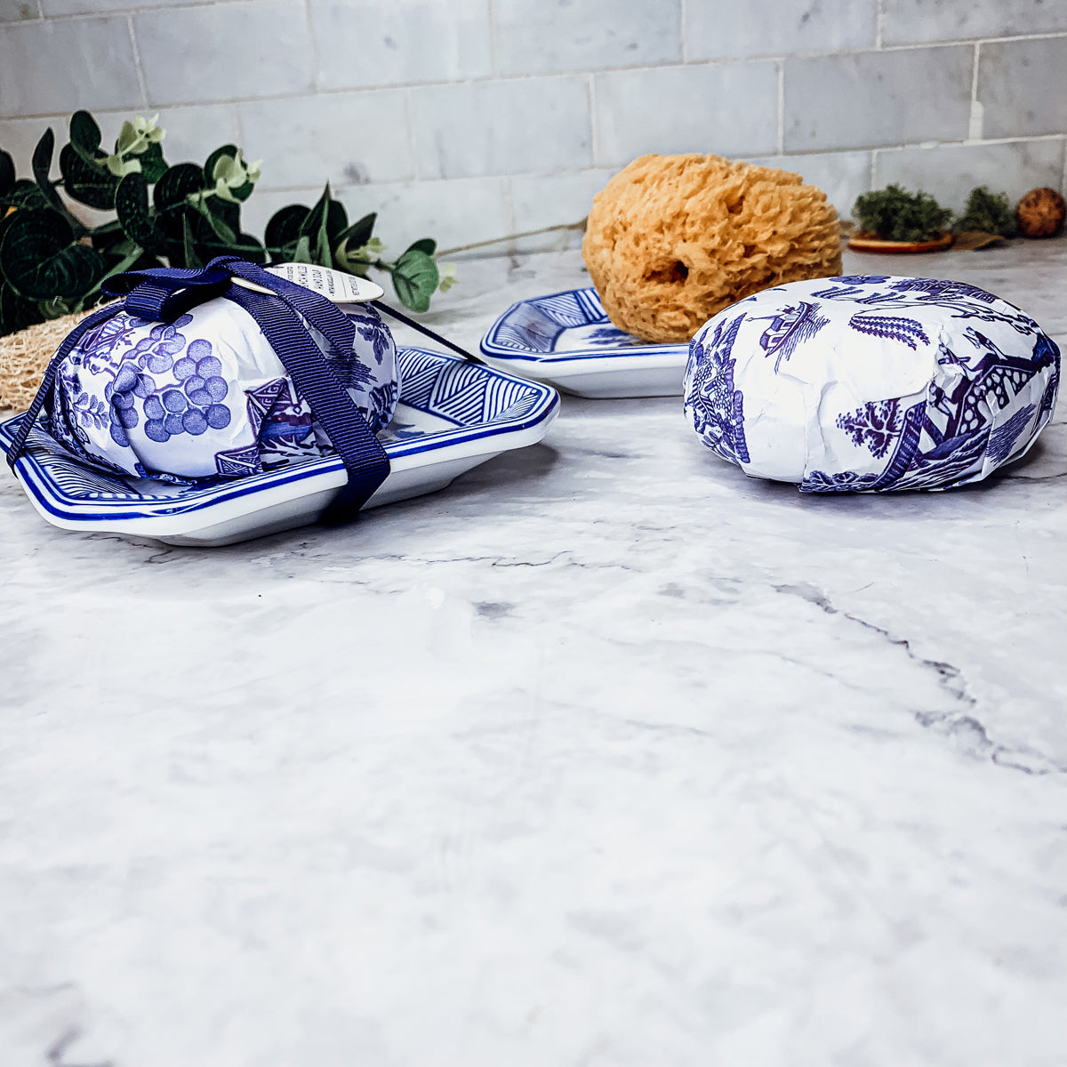 Chinoiserie Soap & Dish Set featuring a sandalwood scented soap on a blue and white porcelain tray, elegantly embossed design.