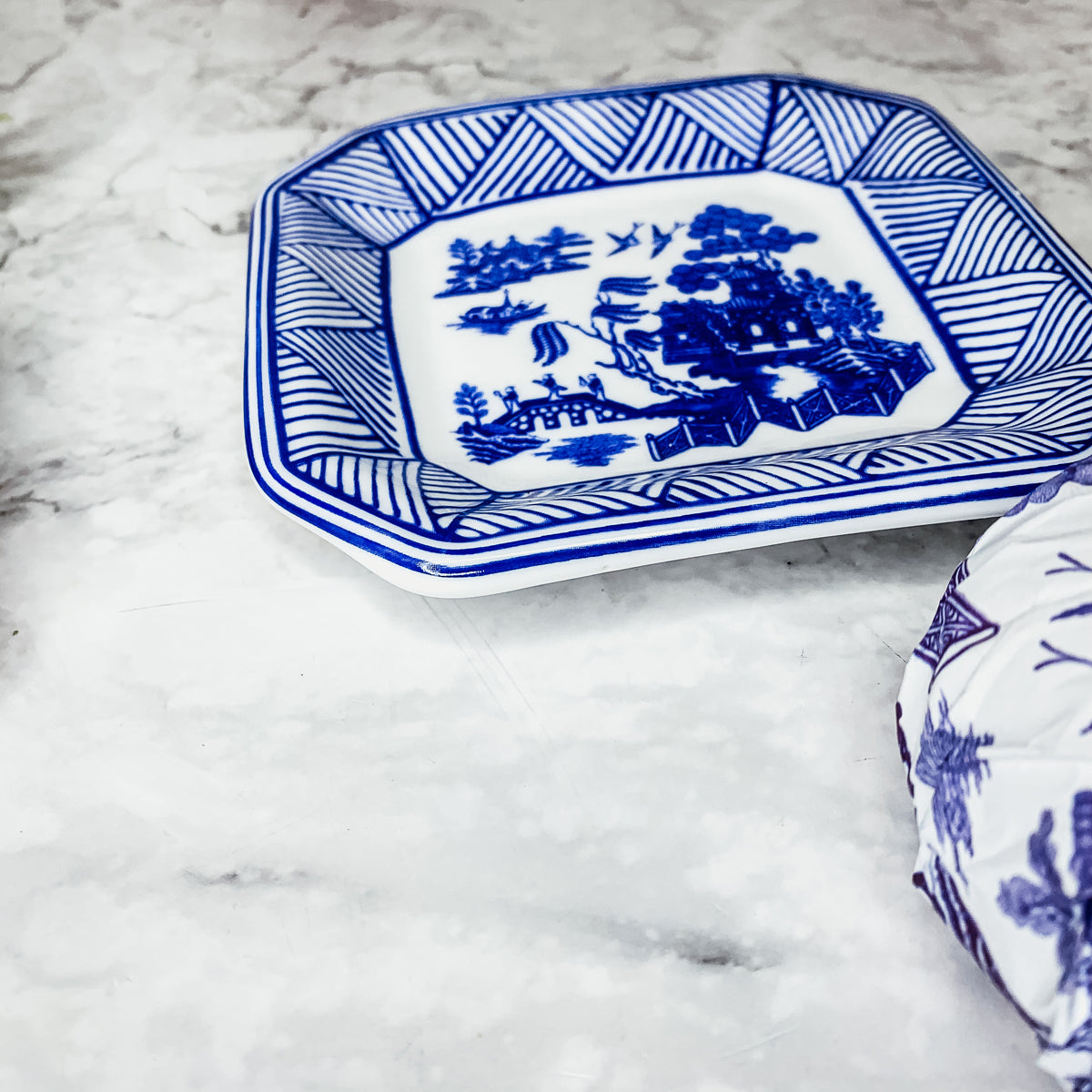 Chinoiserie Soap & Dish Set featuring a sandalwood scented soap on a blue and white porcelain tray, elegantly embossed design.