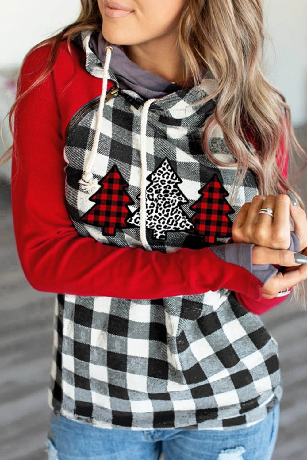 A cozy red plaid asymmetric zip hoodie featuring a Christmas tree print on the chest, perfect for festive occasions.