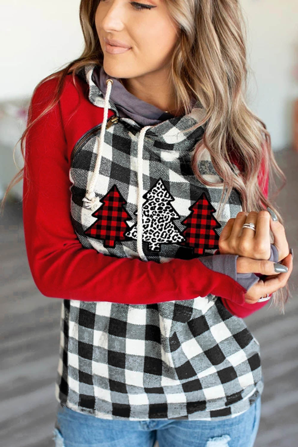 A cozy red plaid asymmetric zip hoodie featuring a Christmas tree print on the chest, perfect for festive occasions.