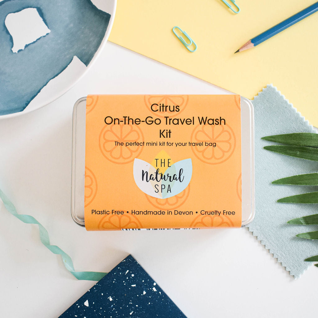 Citrus Mini 'on the go' Travel Wash kit featuring mini soap bars, shampoo, conditioner, and bamboo flannel in a compact travel tin.