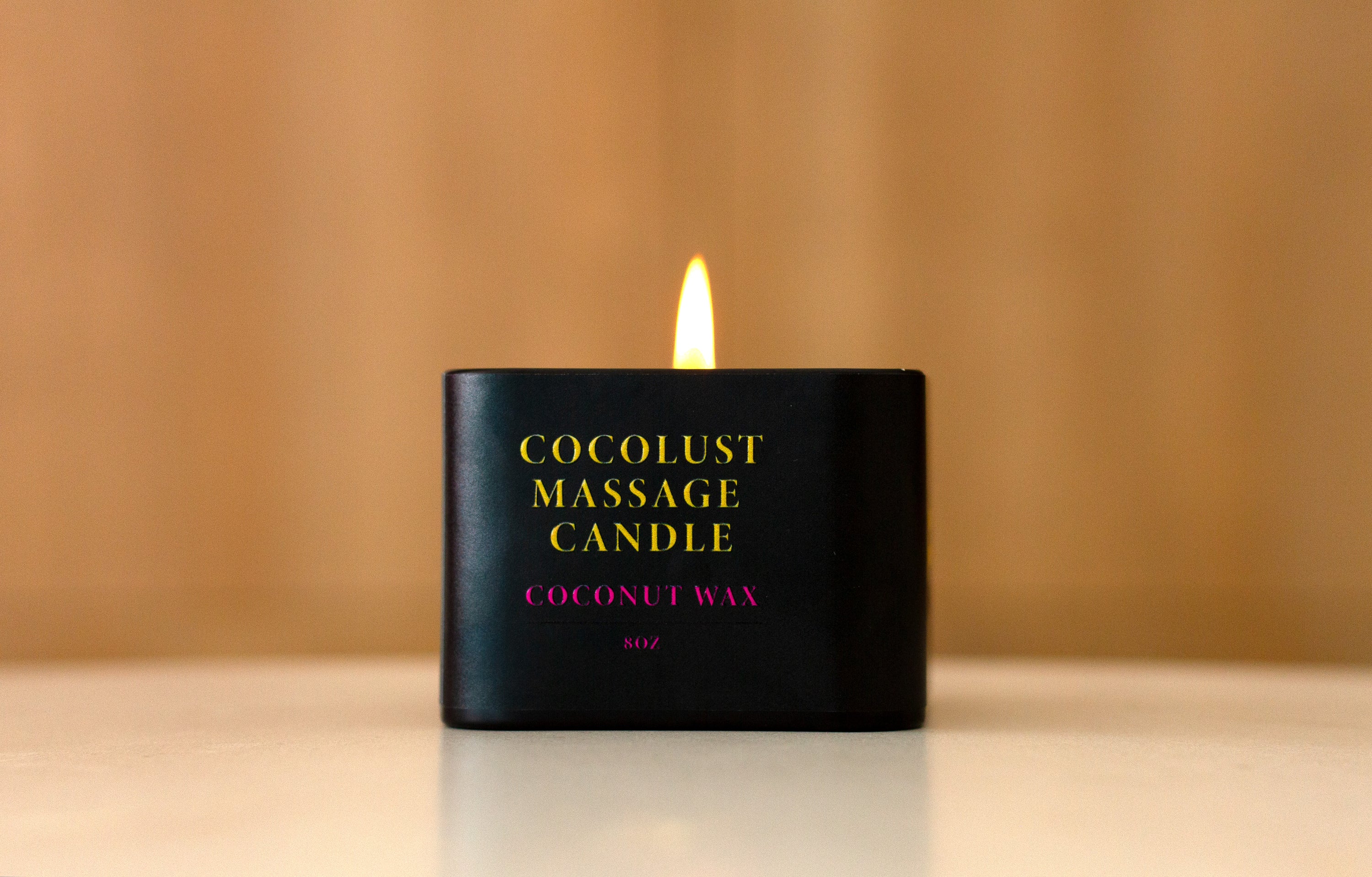 Cocolust Massage Candle in a stylish container, showcasing its coconut wax and inviting light coconut scent.