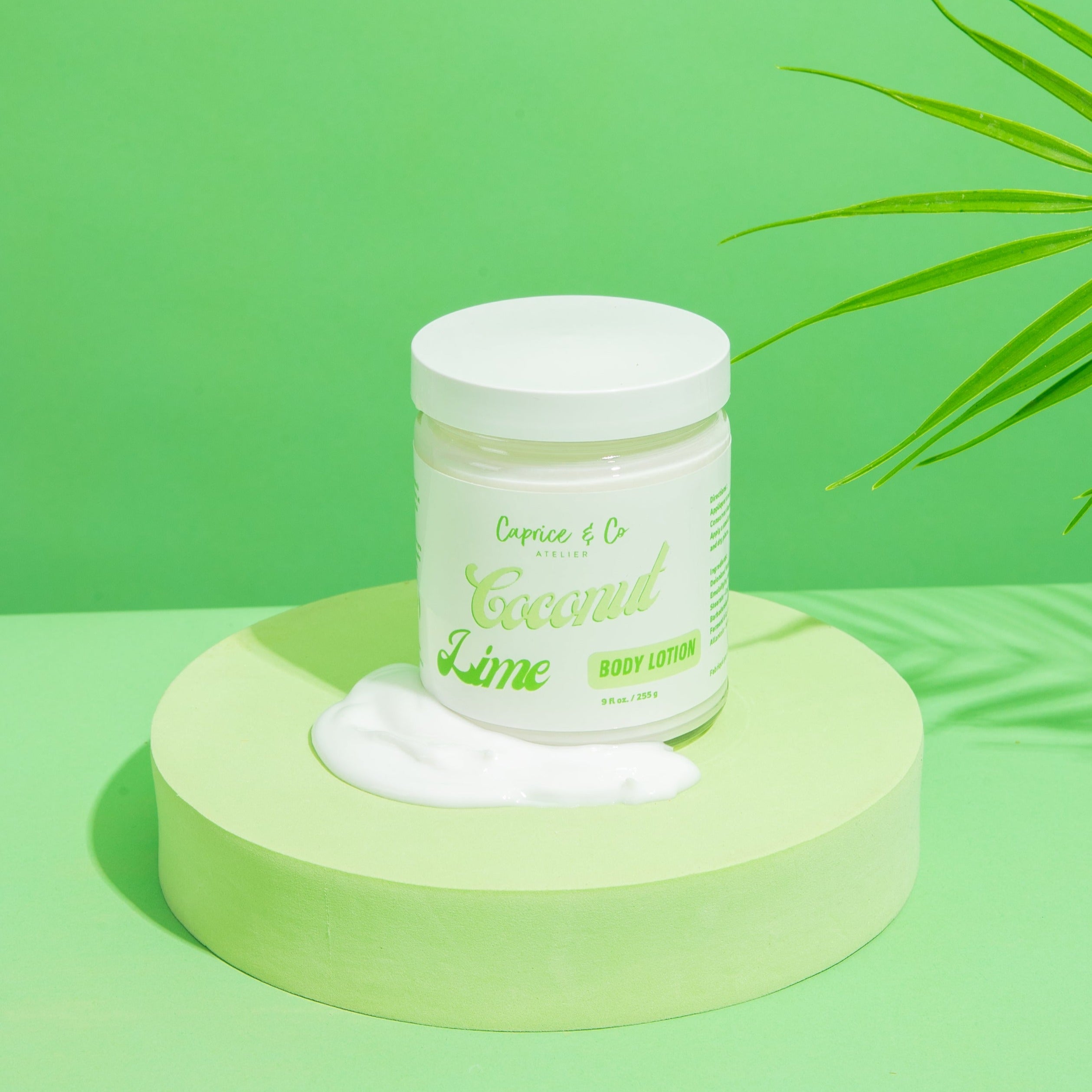 Coconut + Lime Body Lotion in a glass jar, showcasing its creamy texture and tropical scent.