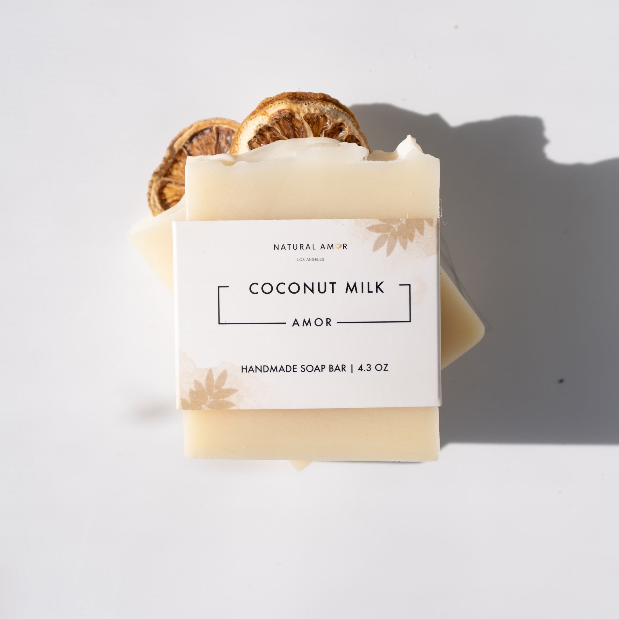 Coconut Milk Amor Soap Bar with dried lemon slices on top, showcasing its natural ingredients and artisan design.