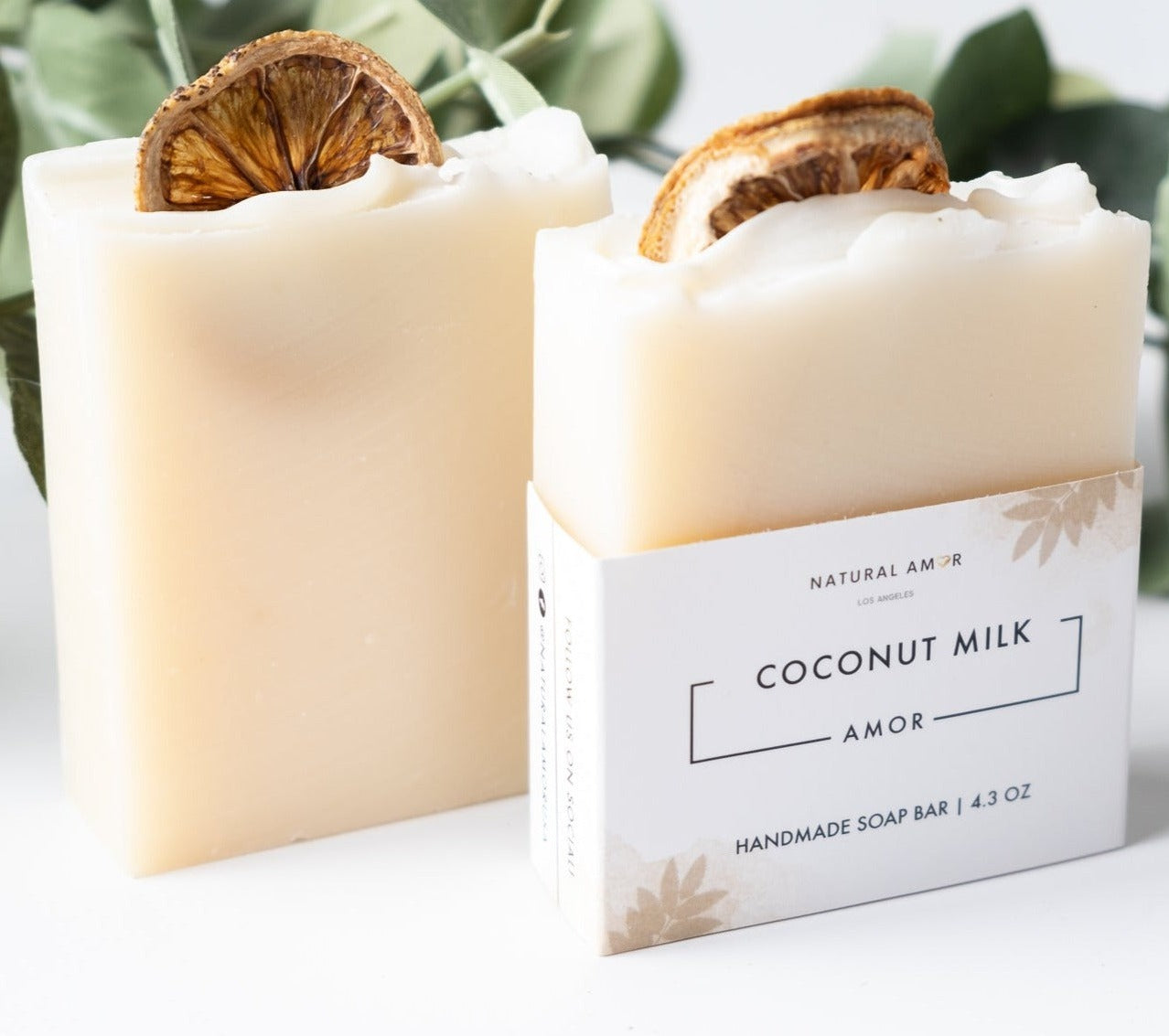 Coconut Milk Amor Soap Bar with dried lemon slices on top, showcasing its natural ingredients and artisan design.