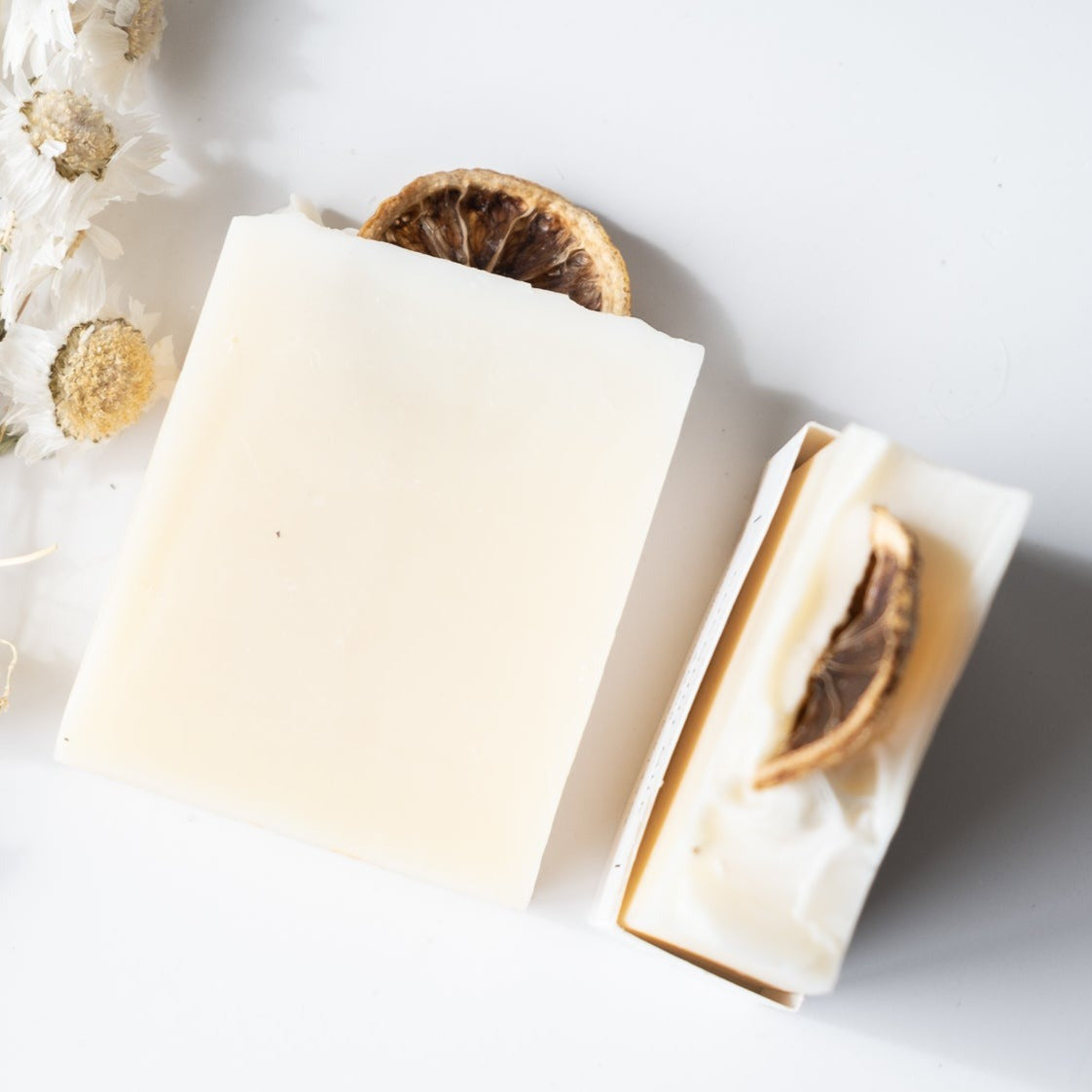 Coconut Milk Amor Soap Bar with dried lemon slices on top, showcasing its natural ingredients and artisan design.