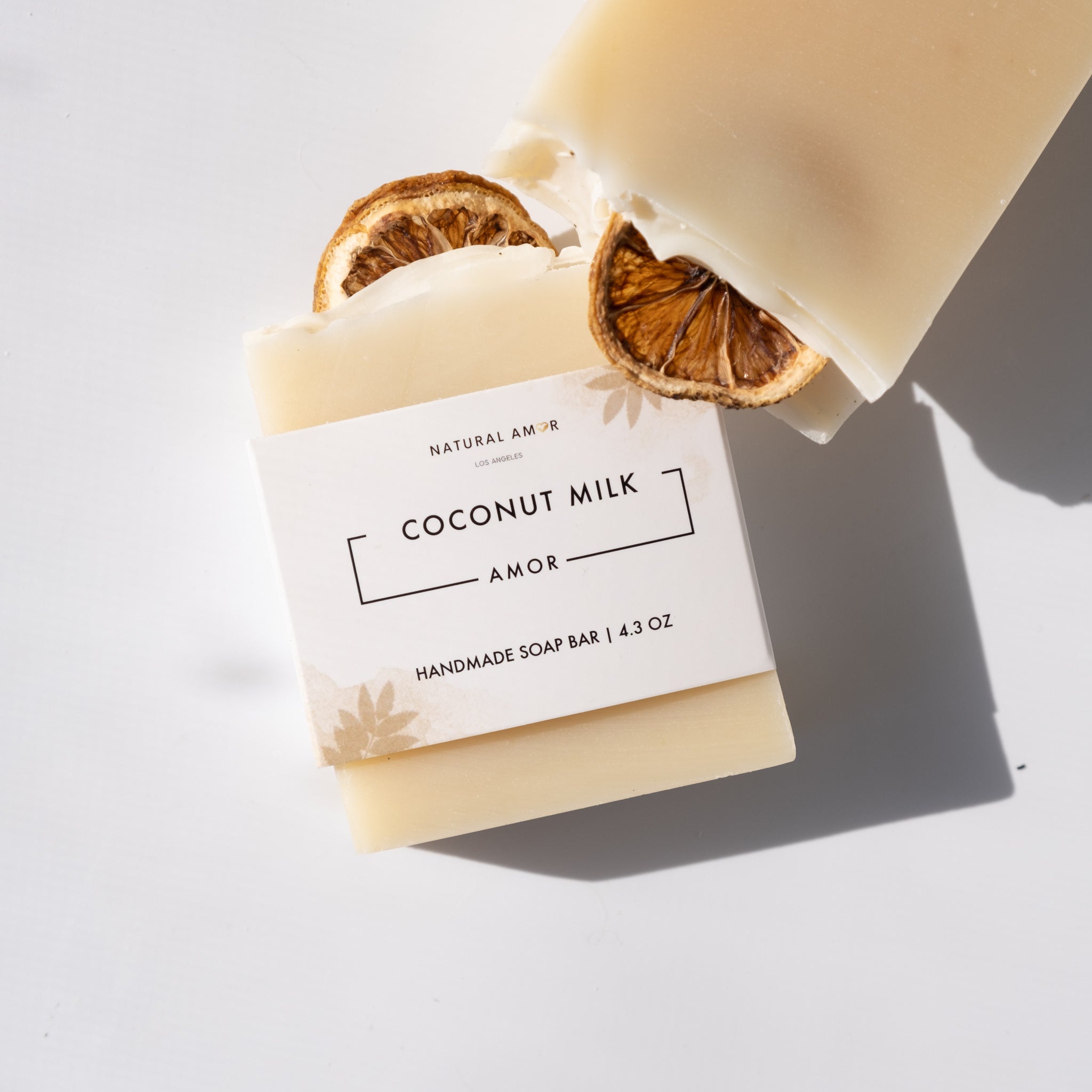 Coconut Milk Amor Soap Bar with dried lemon slices on top, showcasing its natural ingredients and artisan design.