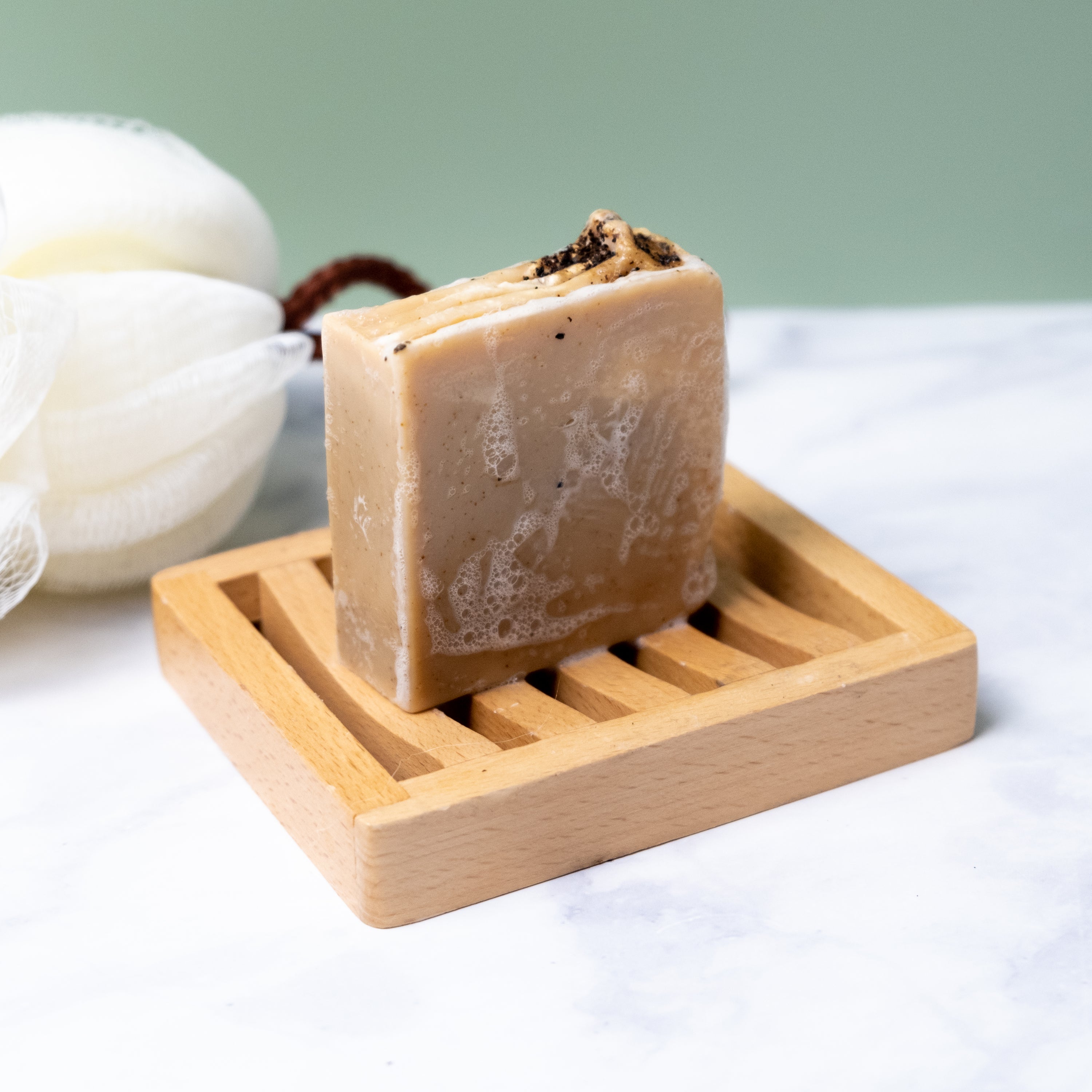 Two bars of Coffee Soap in a stylish box, showcasing natural ingredients and exfoliating walnut shells.