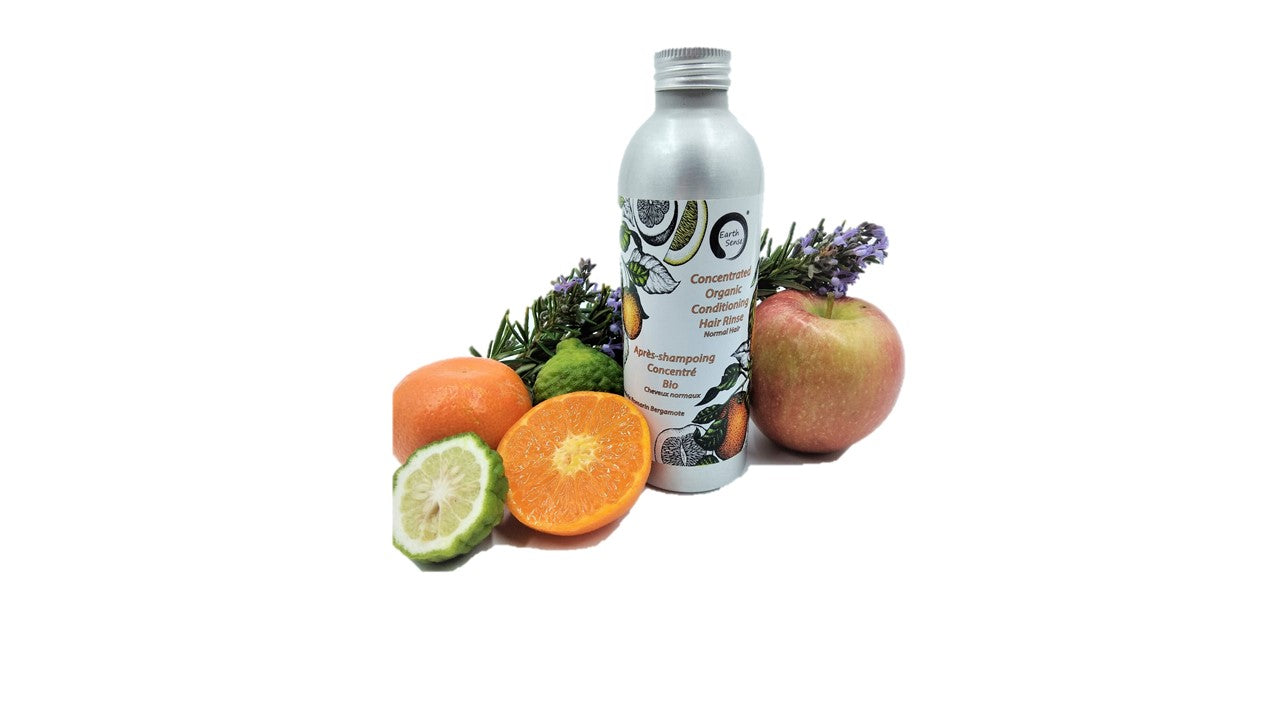 A bottle of Concentrated Organic Conditioning Hair Rinse for Normal Hair, featuring essential oils and organic ingredients.