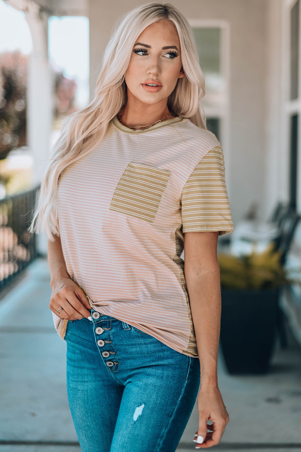 A stylish Contrast Striped Patchwork Tee featuring a round neckline, short sleeves, and a chest pocket, showcasing a vibrant color combination.