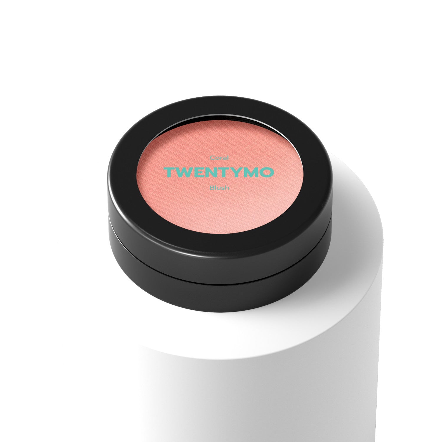 A compact of Coral blush showcasing its silky texture and vibrant color, perfect for achieving a natural glow.