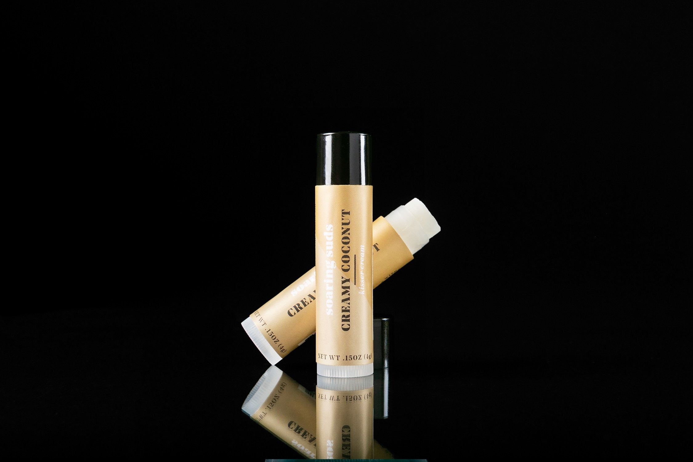 Creamy Coconut Kisser Cream lip balm tube with a tropical coconut design, showcasing its natural ingredients.