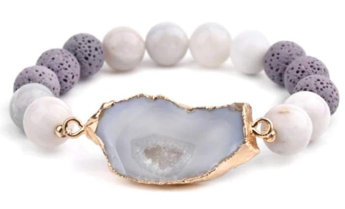 A stylish Crystal and Gold Lava Stone Essential Oil Bracelet featuring natural lava stones and elegant gold accents, perfect for aromatherapy.