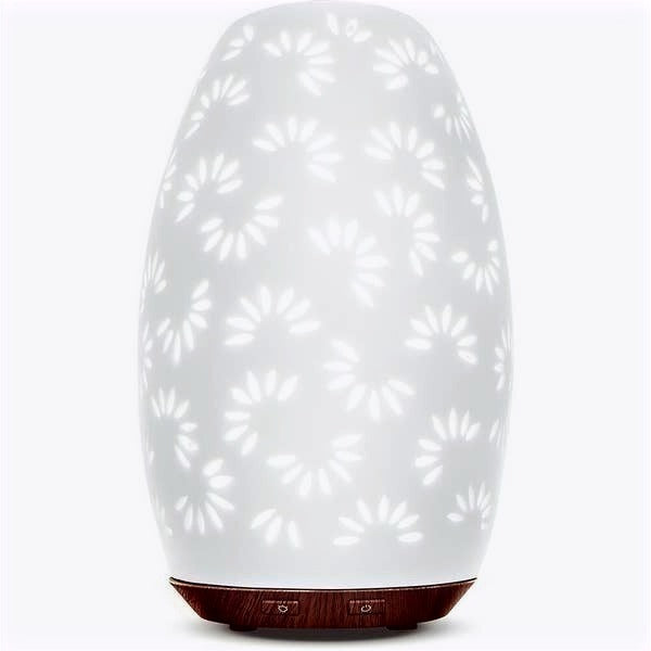 Handcrafted ceramic Daisy Essential Oil diffuser with faux flame candle, designed for aromatherapy and ambiance.