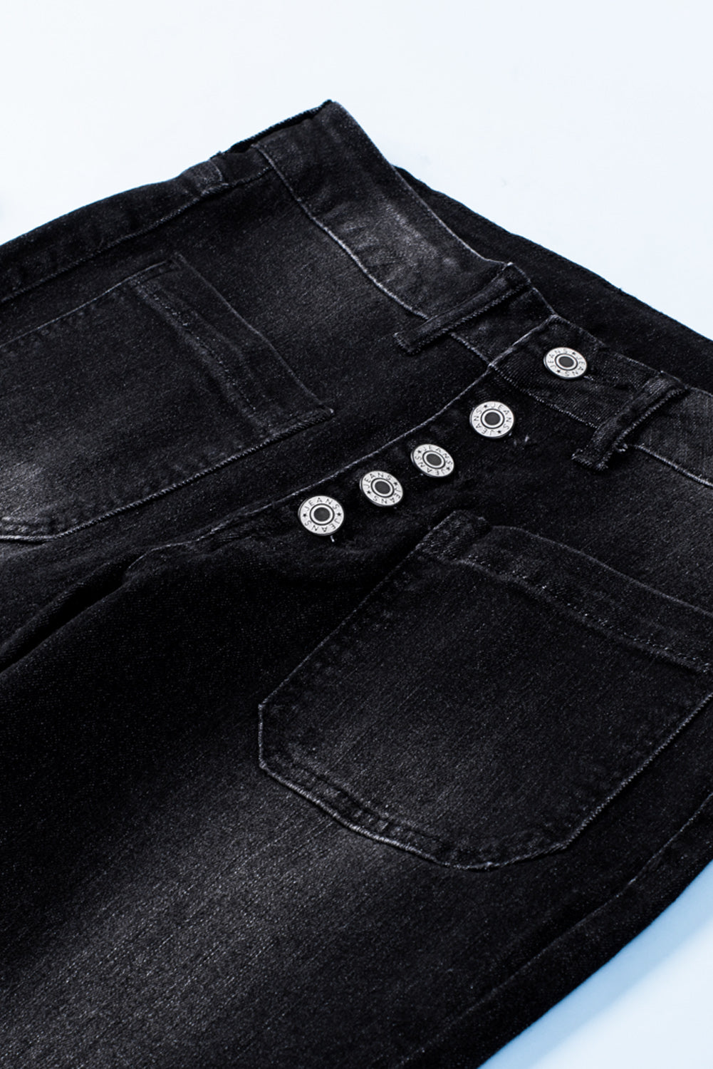 Dark blue skinny jeans featuring a button fly closure and pockets, designed for a stylish and comfortable fit.