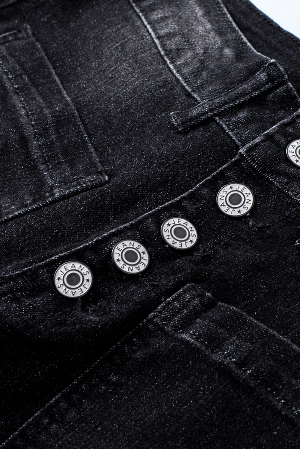 Dark blue skinny jeans featuring a button fly closure and pockets, designed for a stylish and comfortable fit.