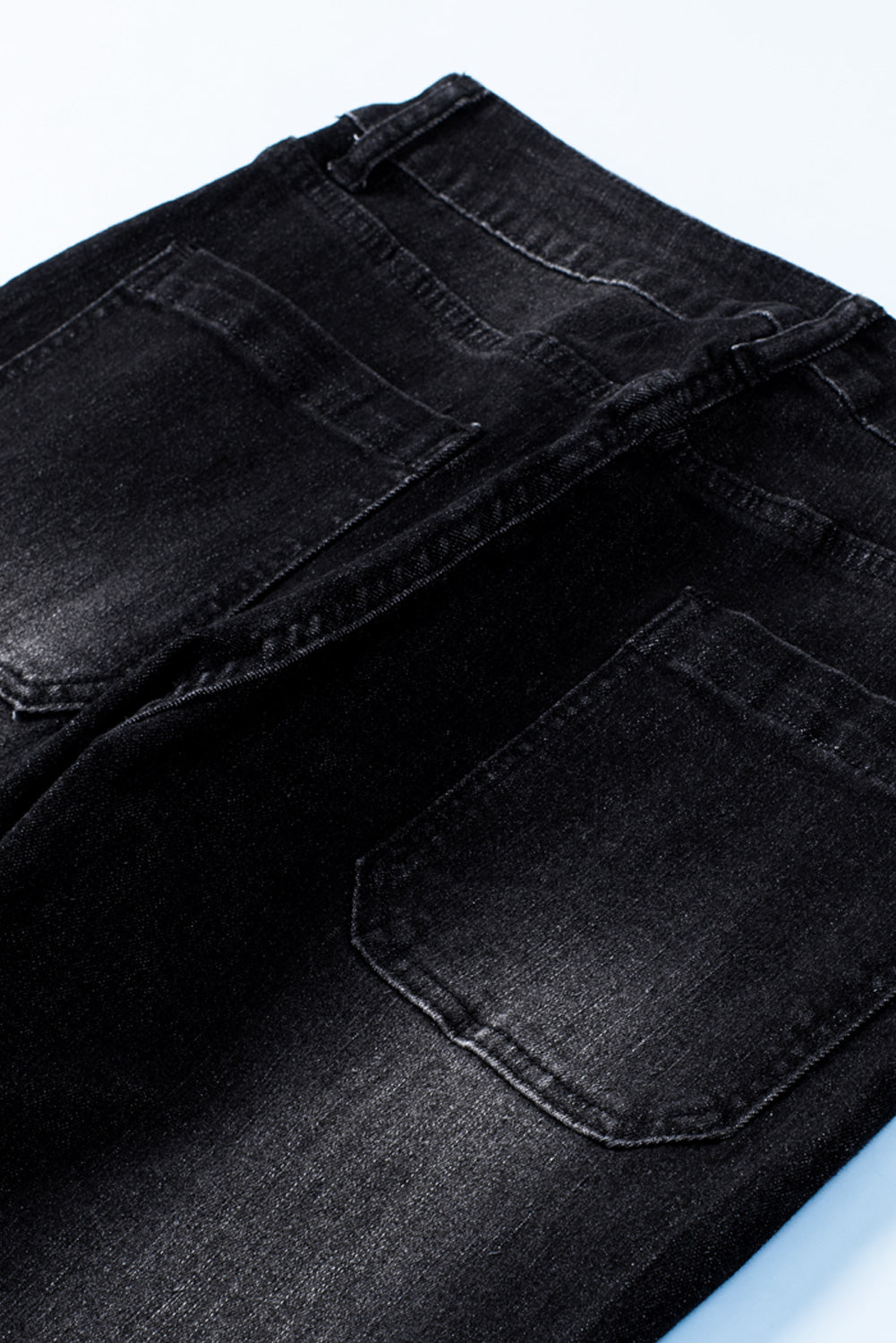 Dark blue skinny jeans featuring a button fly closure and pockets, designed for a stylish and comfortable fit.