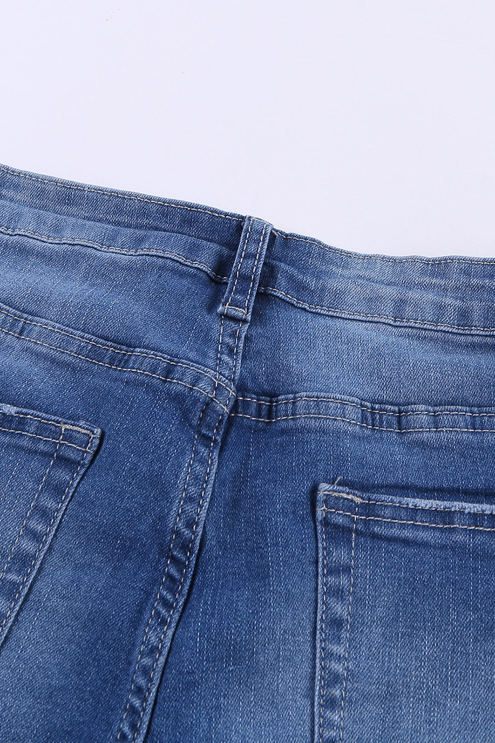 A pair of dark blue frayed hem denim shorts displayed on a white background, showcasing the stylish distressed design and pockets.