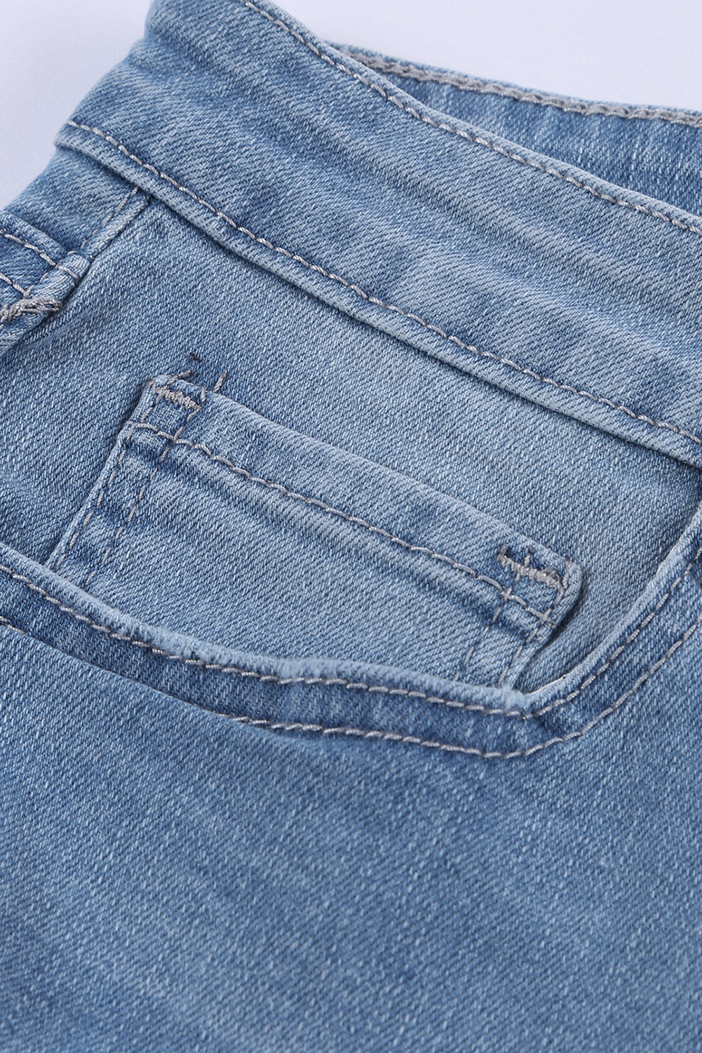 A pair of dark blue frayed hem denim shorts displayed on a white background, showcasing the stylish distressed design and pockets.