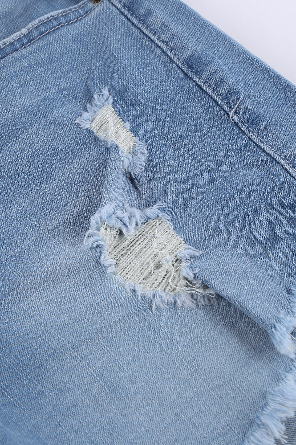 A pair of dark blue frayed hem denim shorts displayed on a white background, showcasing the stylish distressed design and pockets.