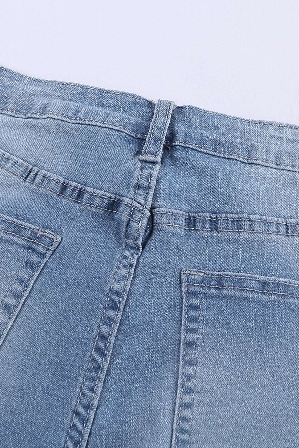 A pair of dark blue frayed hem denim shorts displayed on a white background, showcasing the stylish distressed design and pockets.